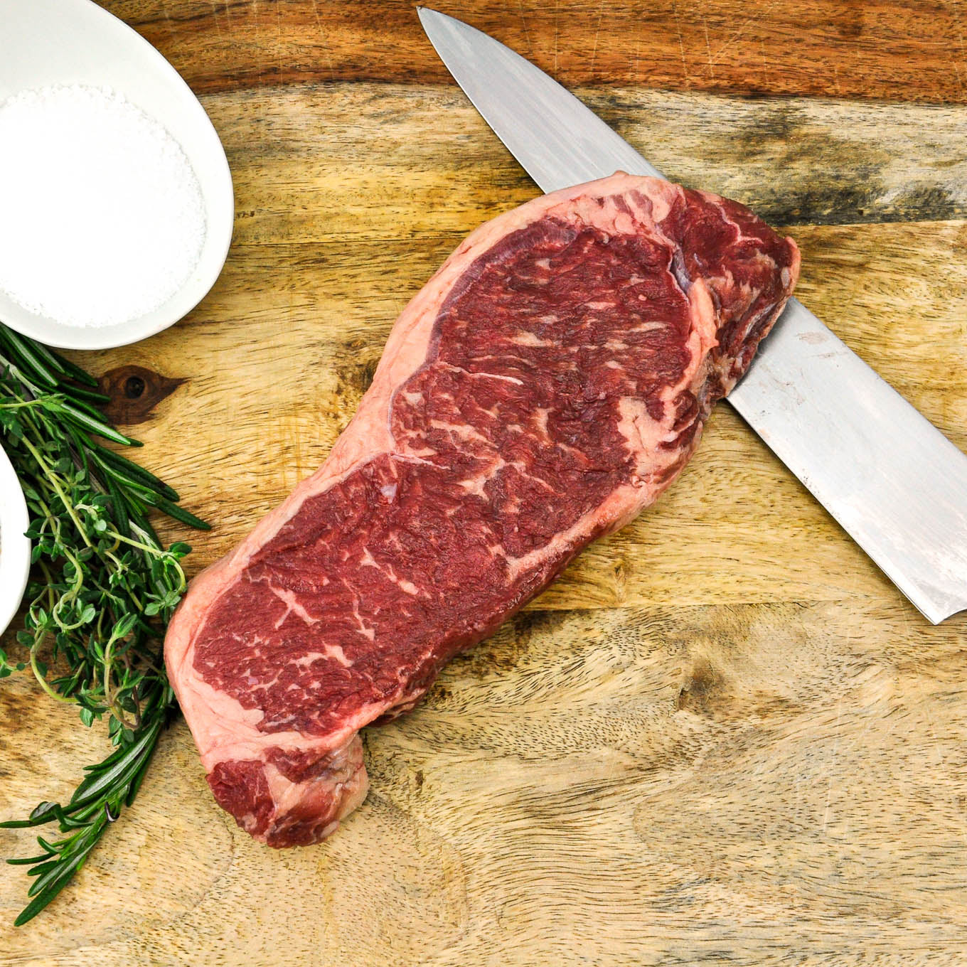 local angus beef strip steak raw