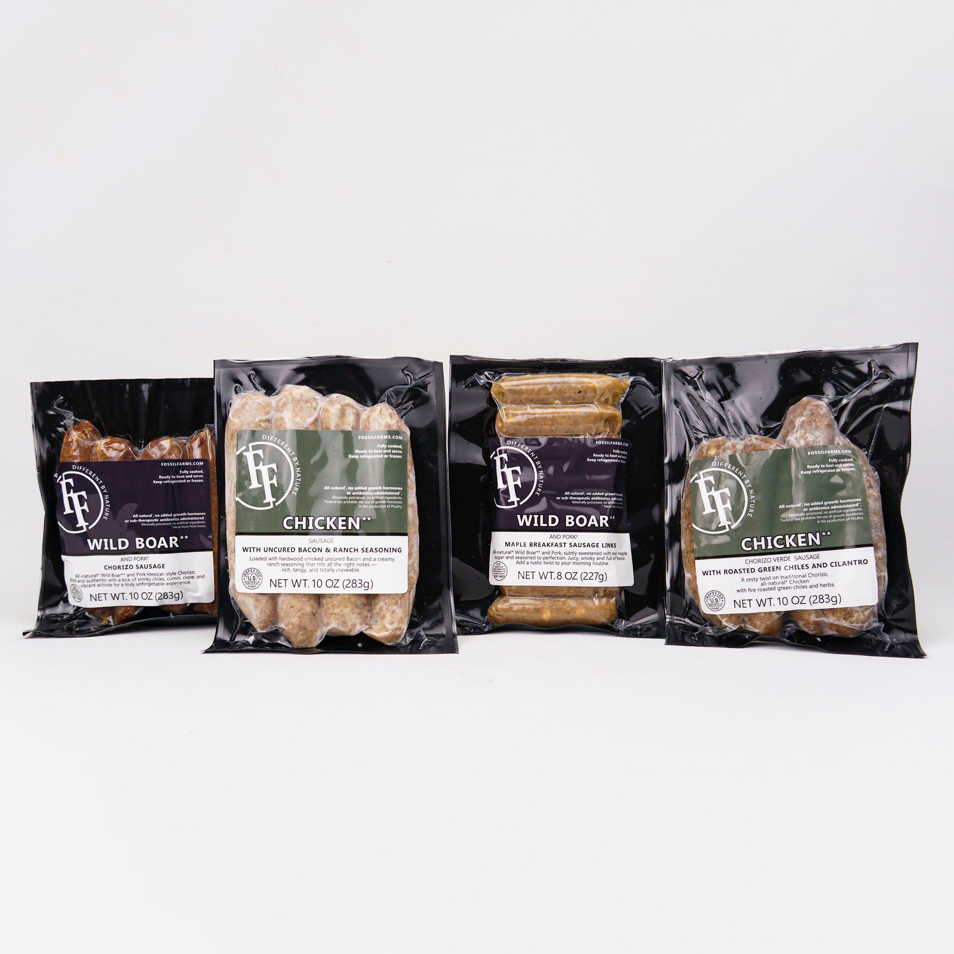 Four packages of wild game meat on a white background