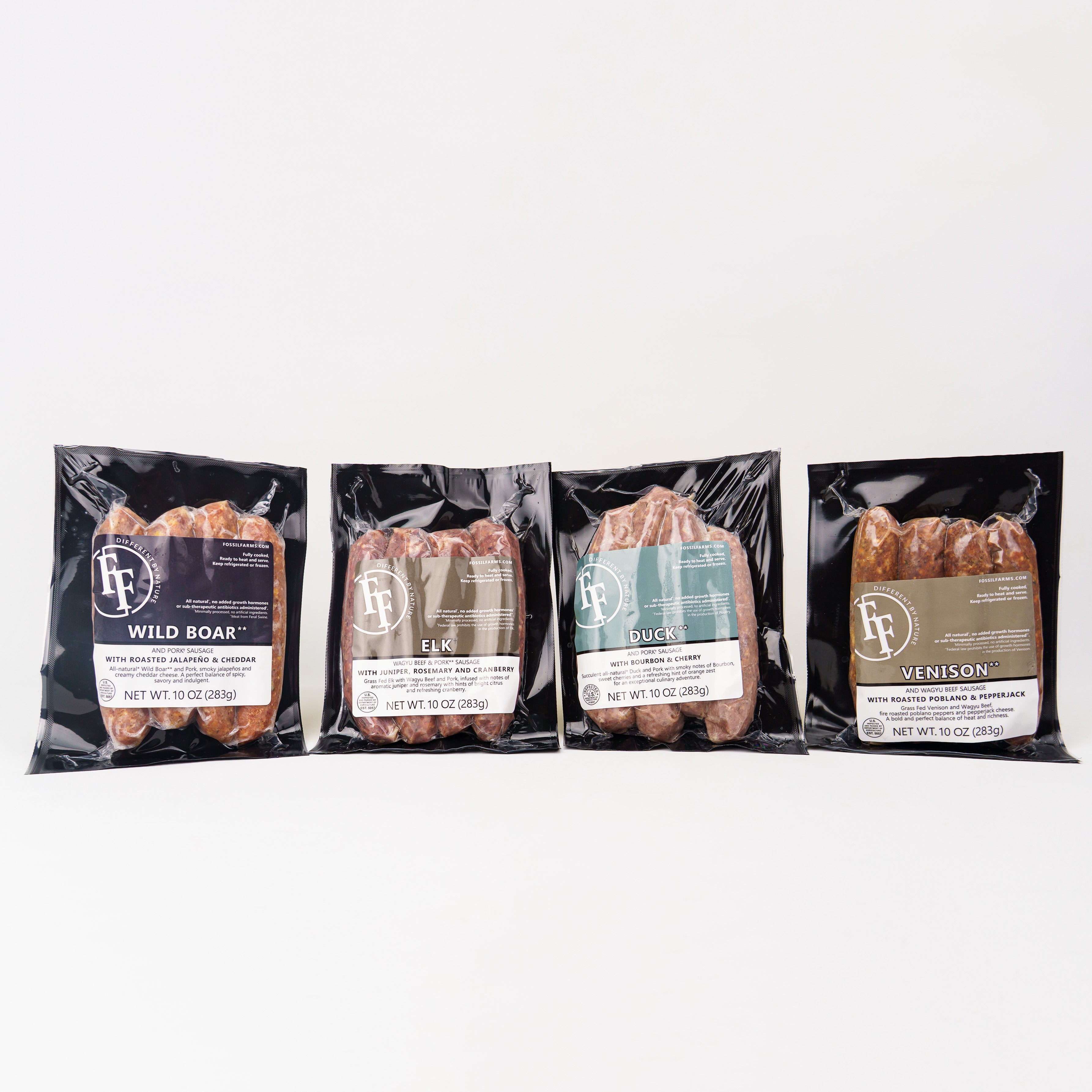 Four packages of wild game meat with visible branding on a white background