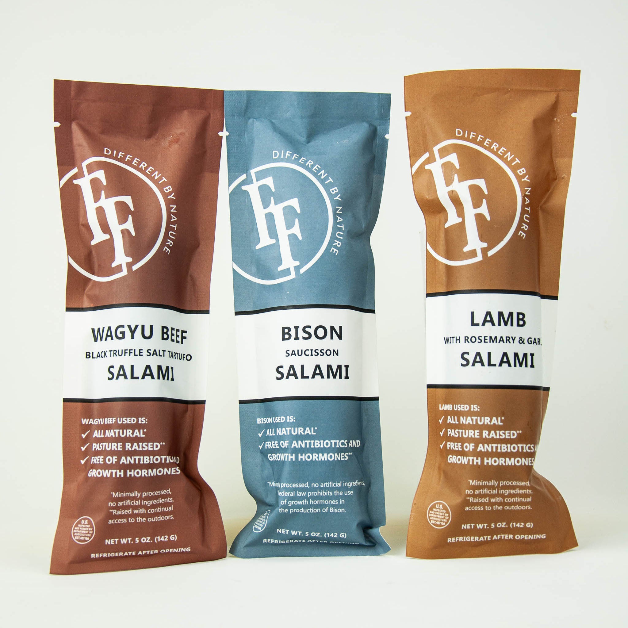 Three packages of FF Salami with different flavors on a white background
