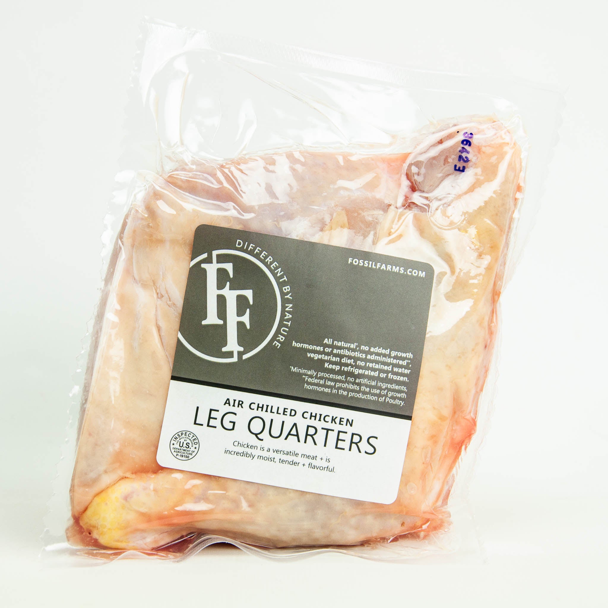 Packaged chicken leg quarters with Fossil Farms label on a white background