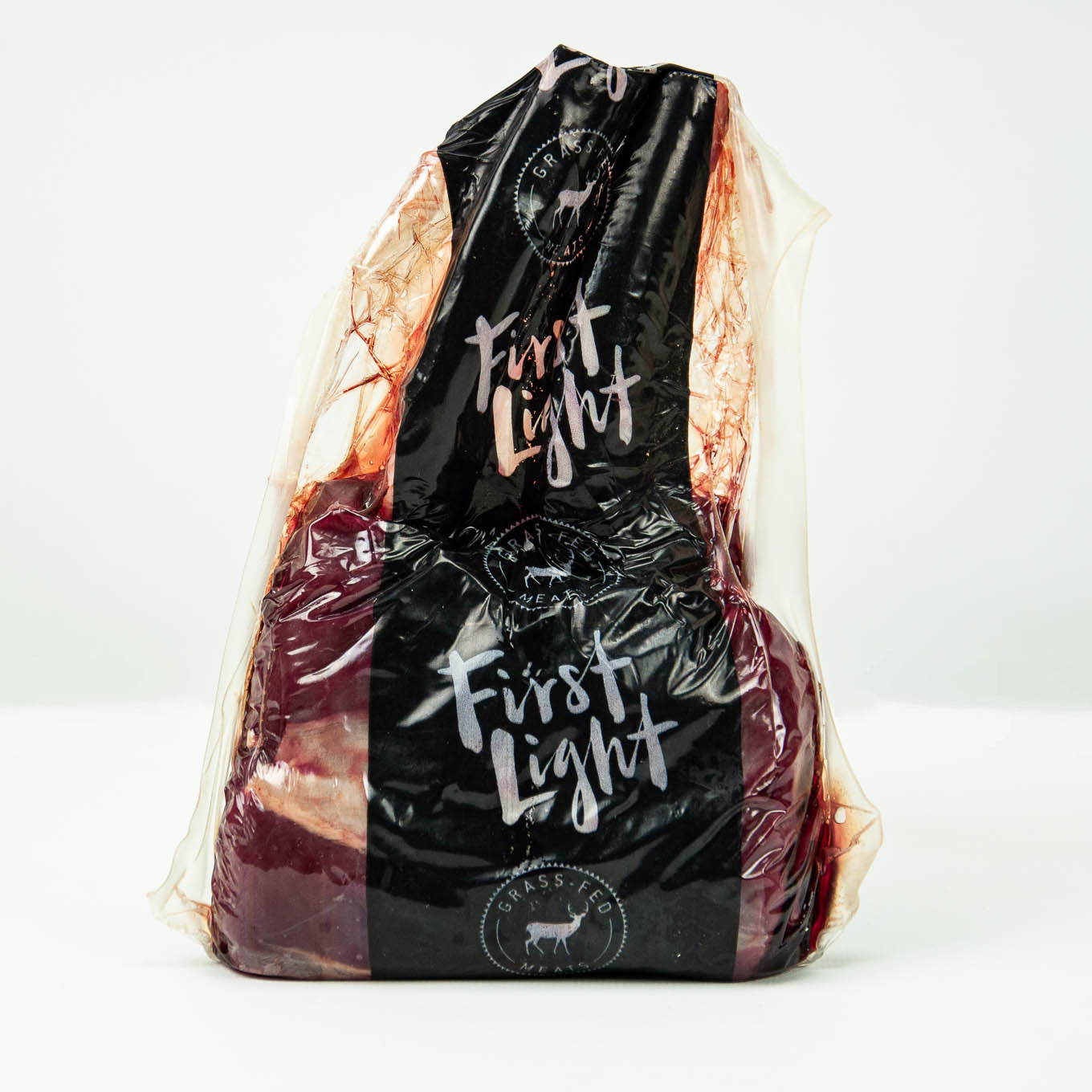 Packaged meat with 'First Light' branding on a white background
