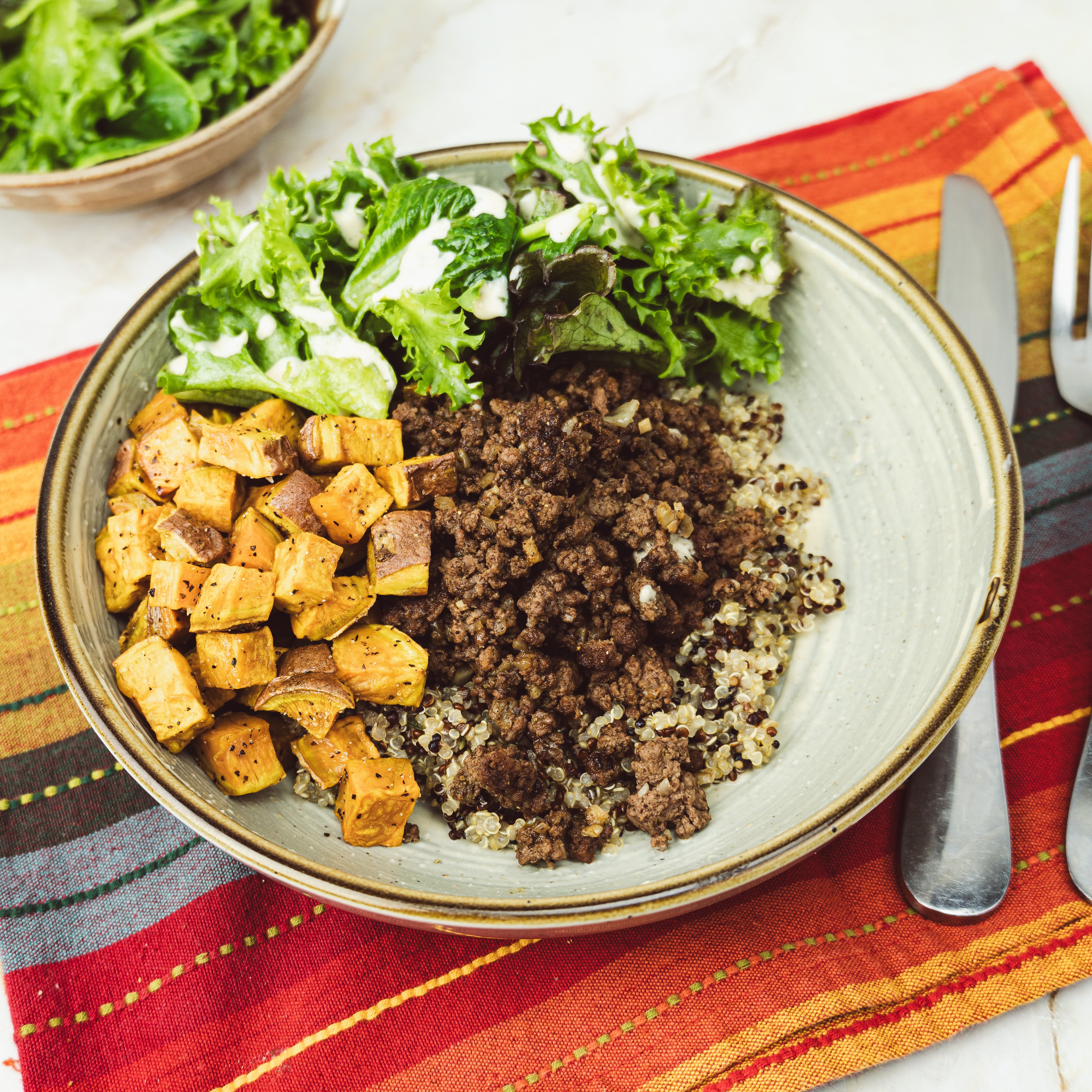 a bowl of quinoa with sweet potatoes, and ground meat