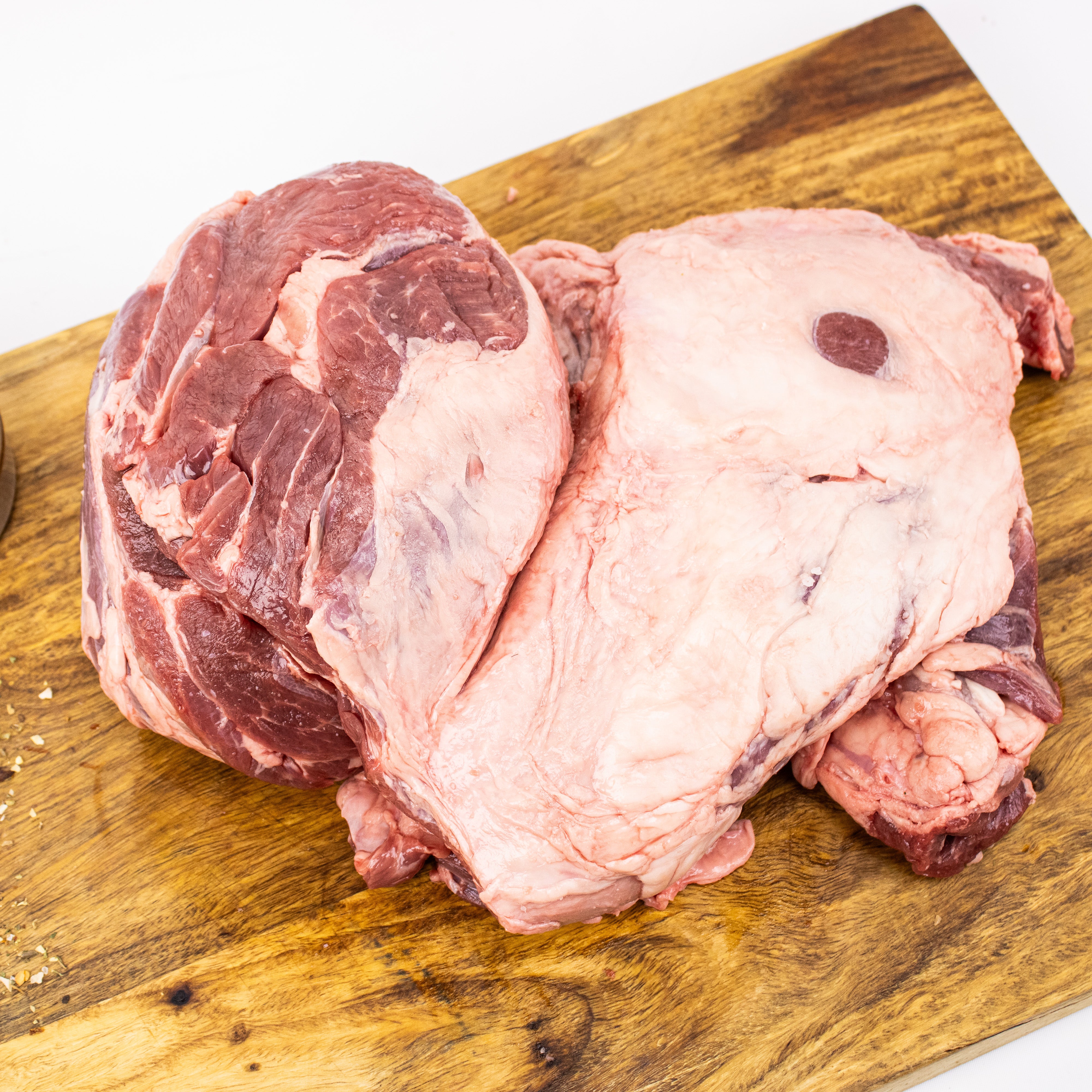 Packaged lamb leg with labels on a white background