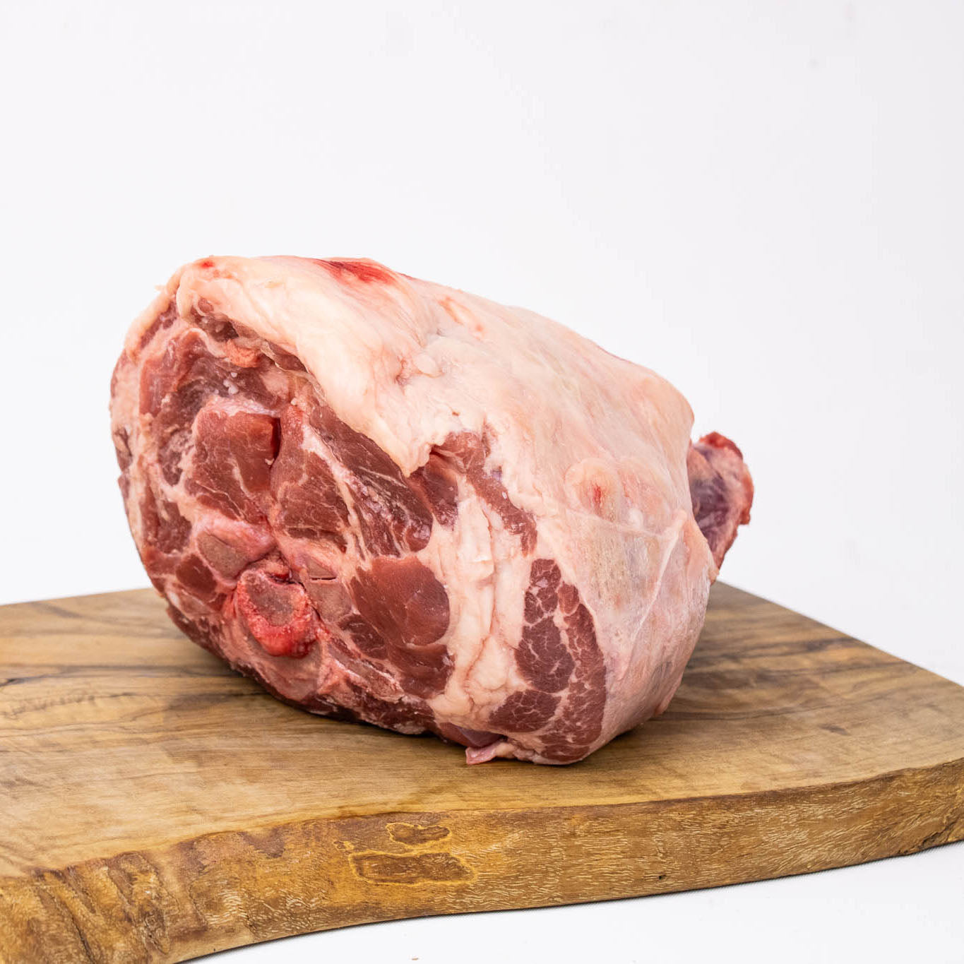 Raw meat on a wooden cutting board with a white background