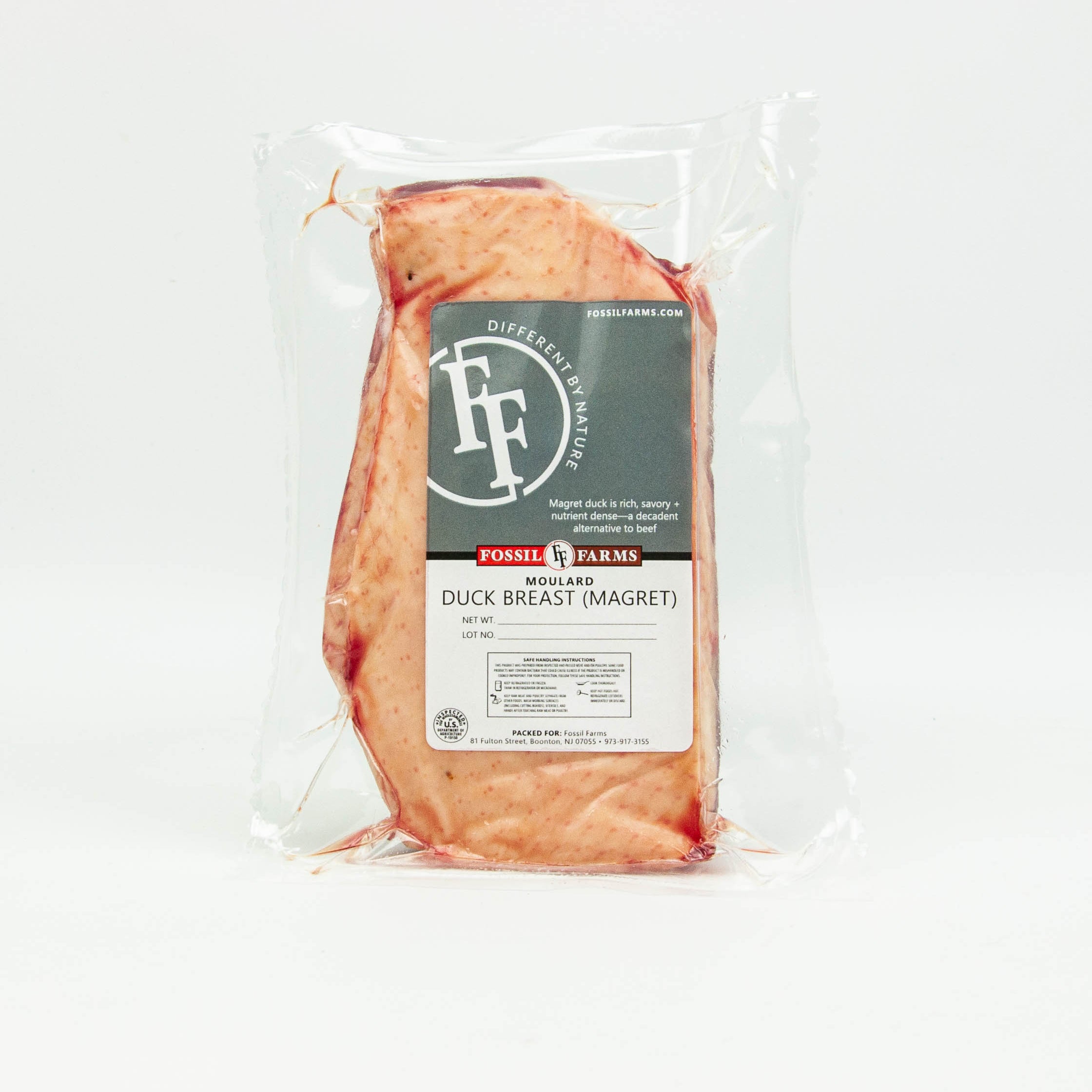 Packaged duck breast with Fossil Farms label on a white background