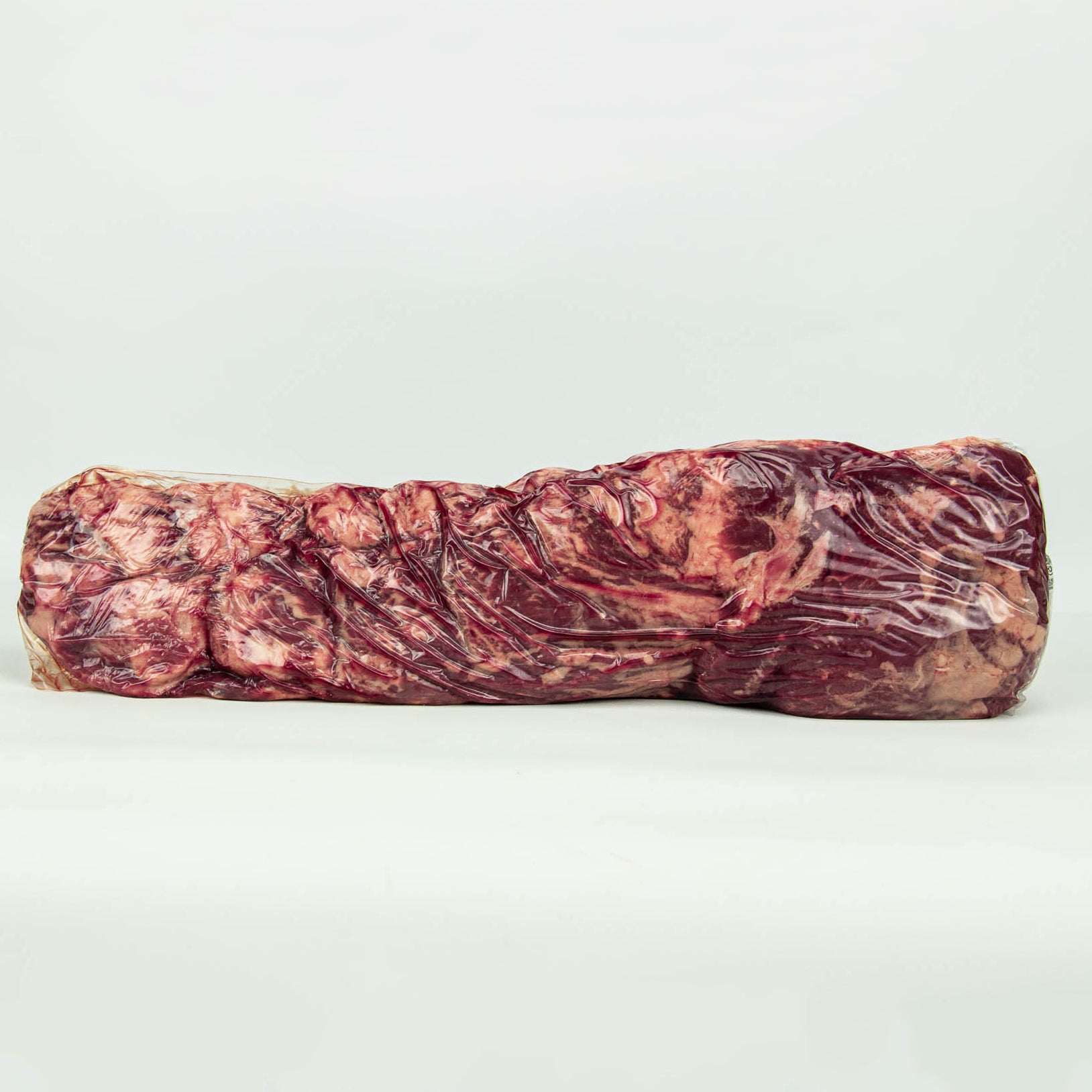 Raw meatloaf on a white background