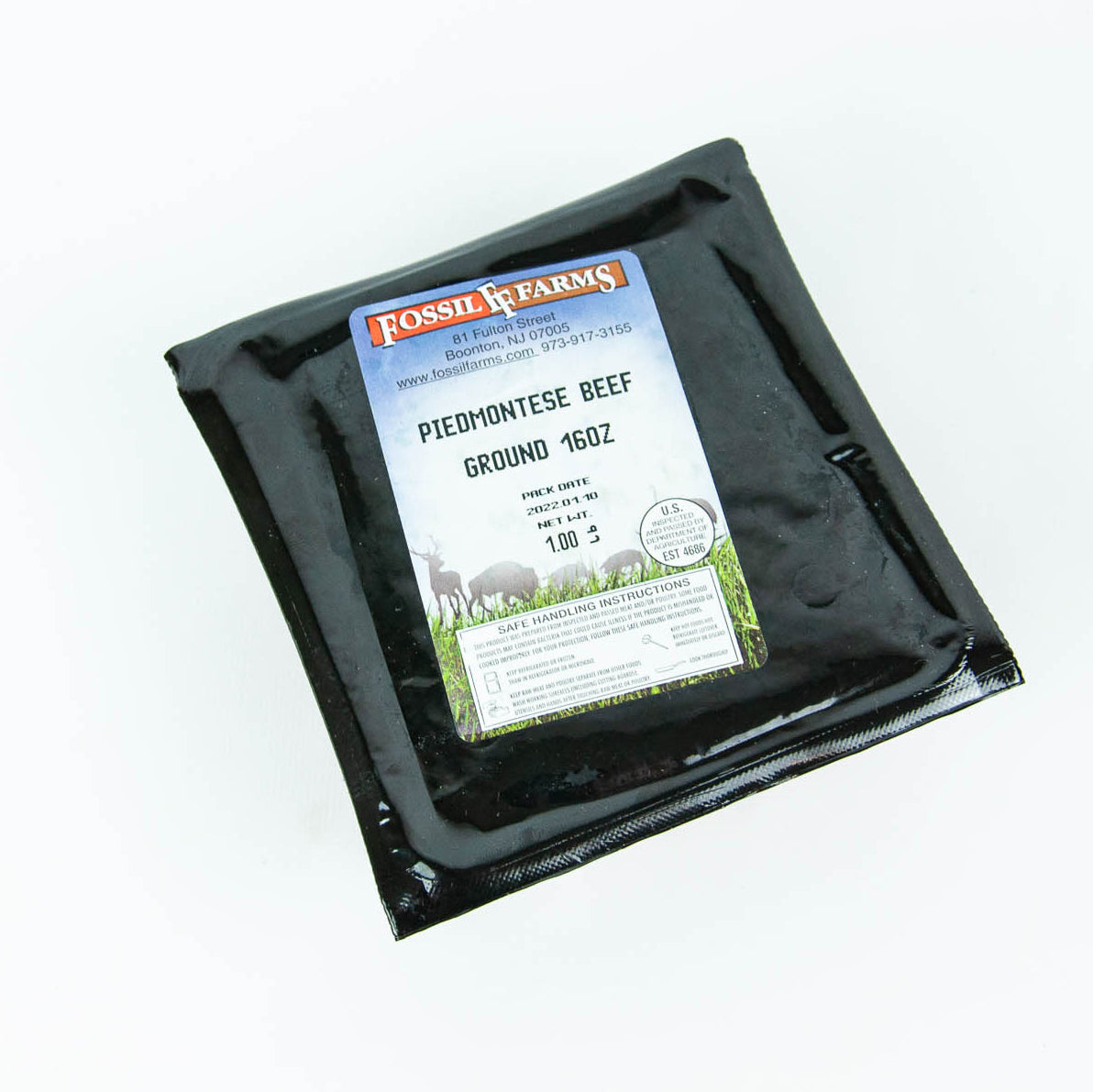 Packaged ground beef with Fossils Farms label on a white background