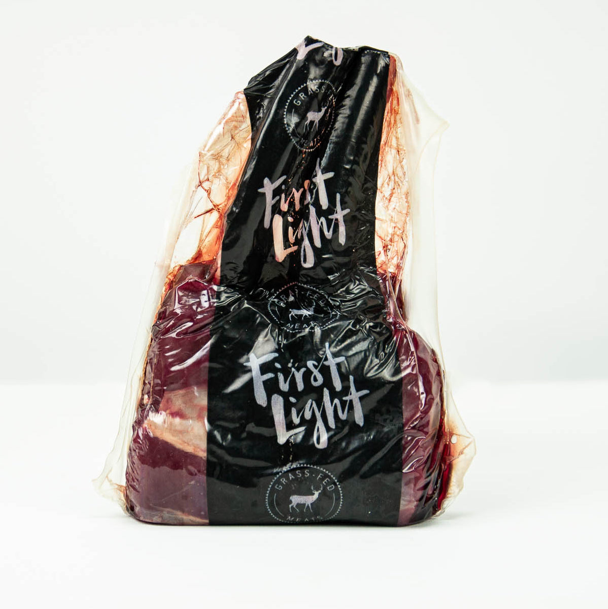 Packaged meat with 'First Light' branding on a white background