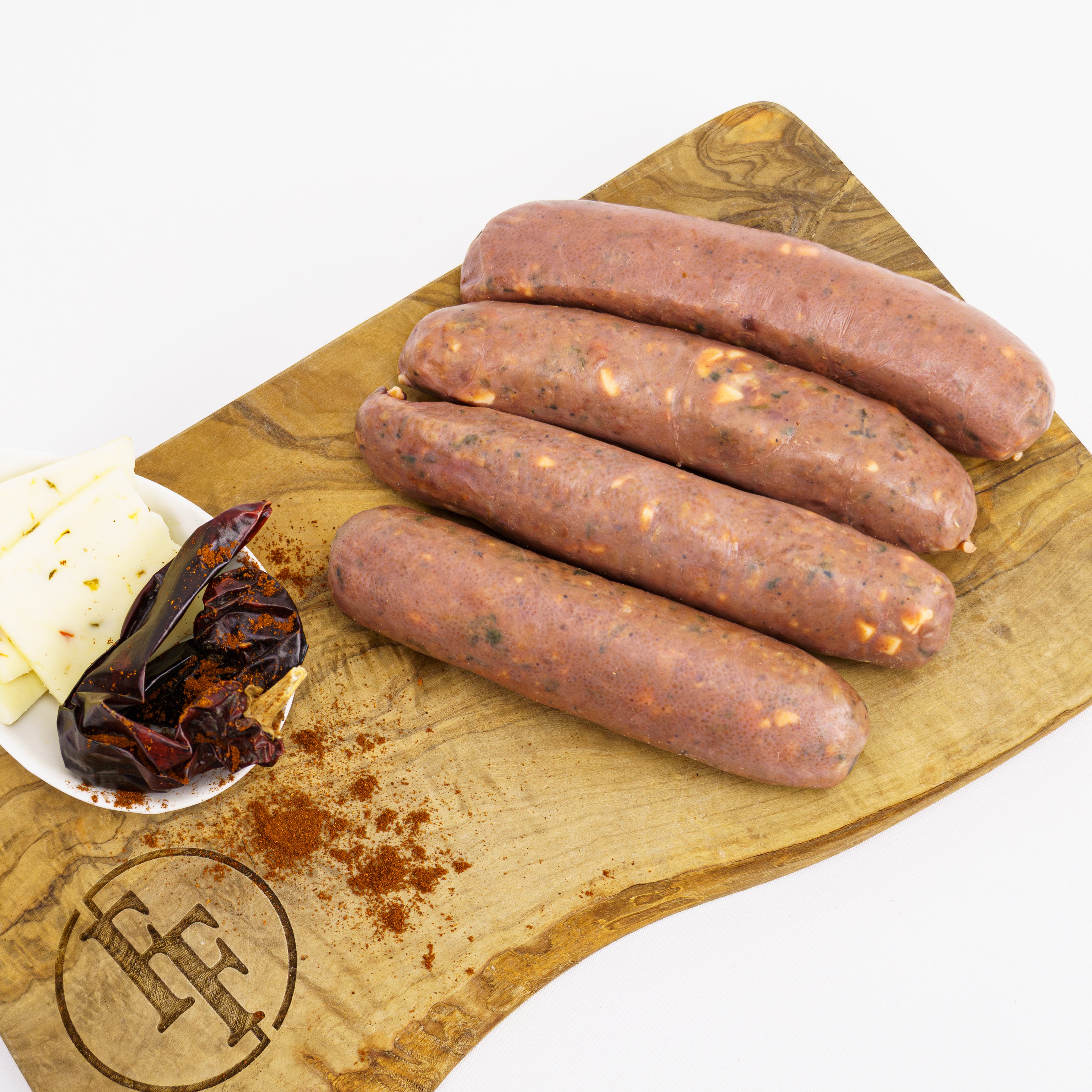 four raw venison sausages