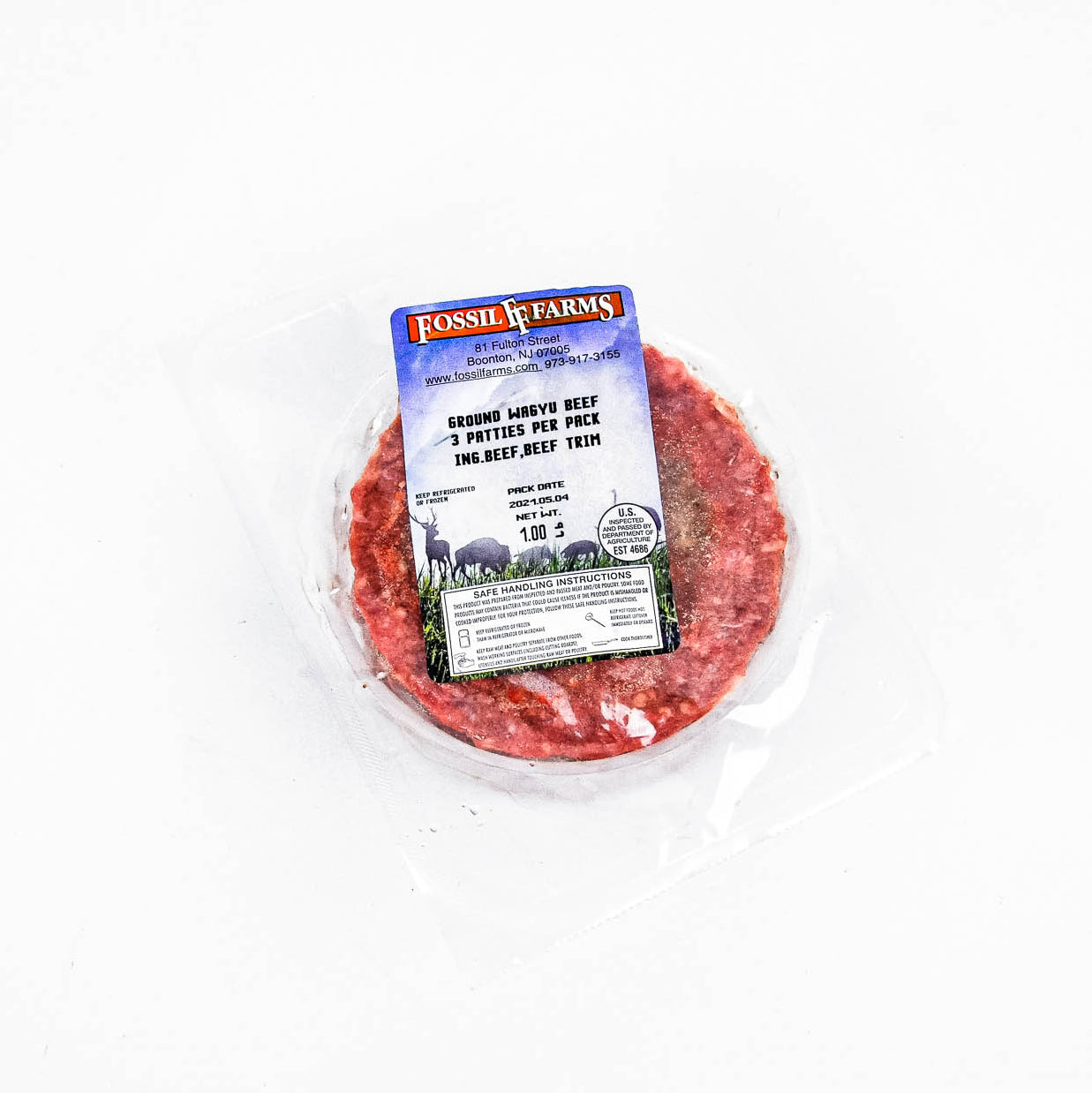 Ground beef patty in a packaging with a Fossil Farms label on a white background