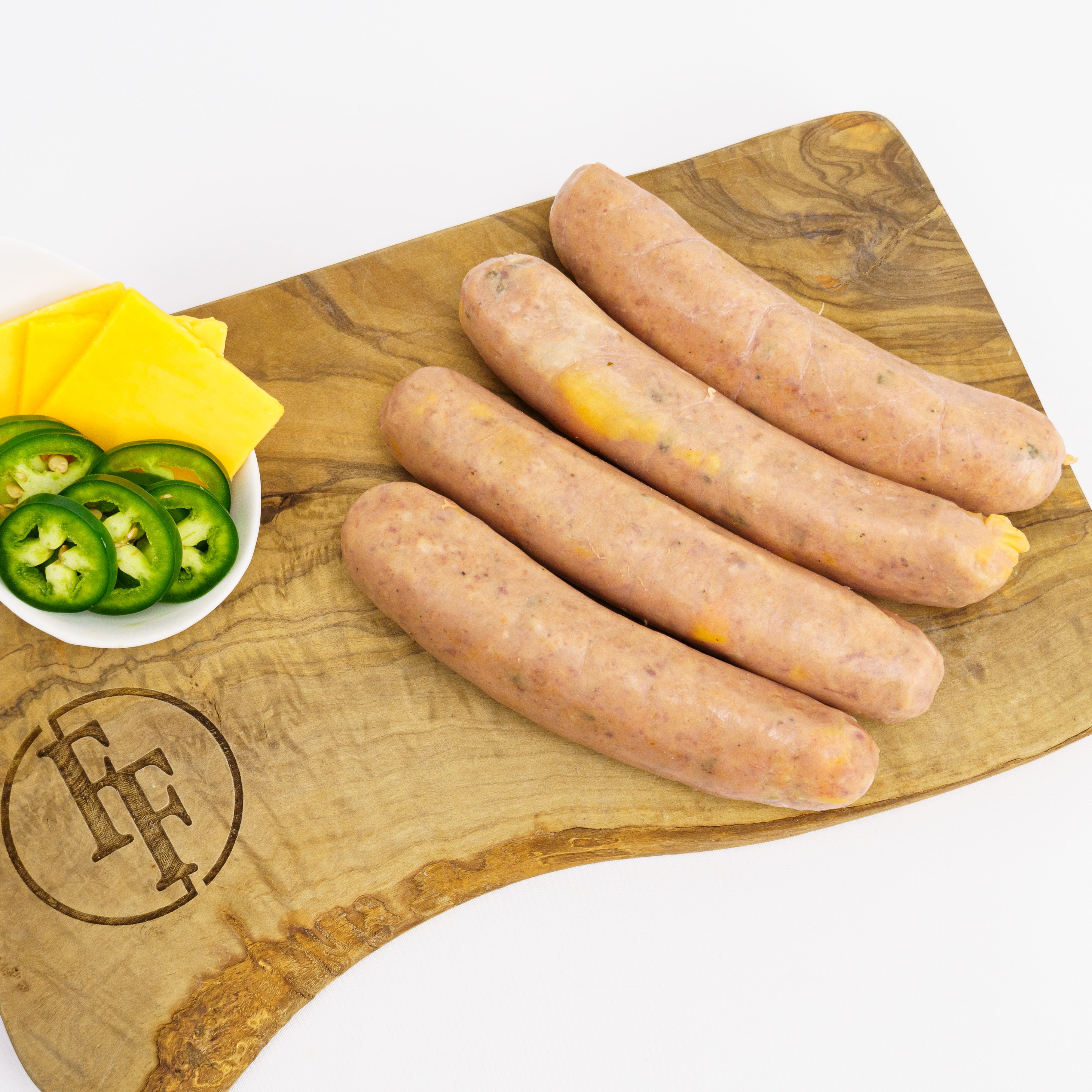 four uncooked jalapeno and cheddar sausages