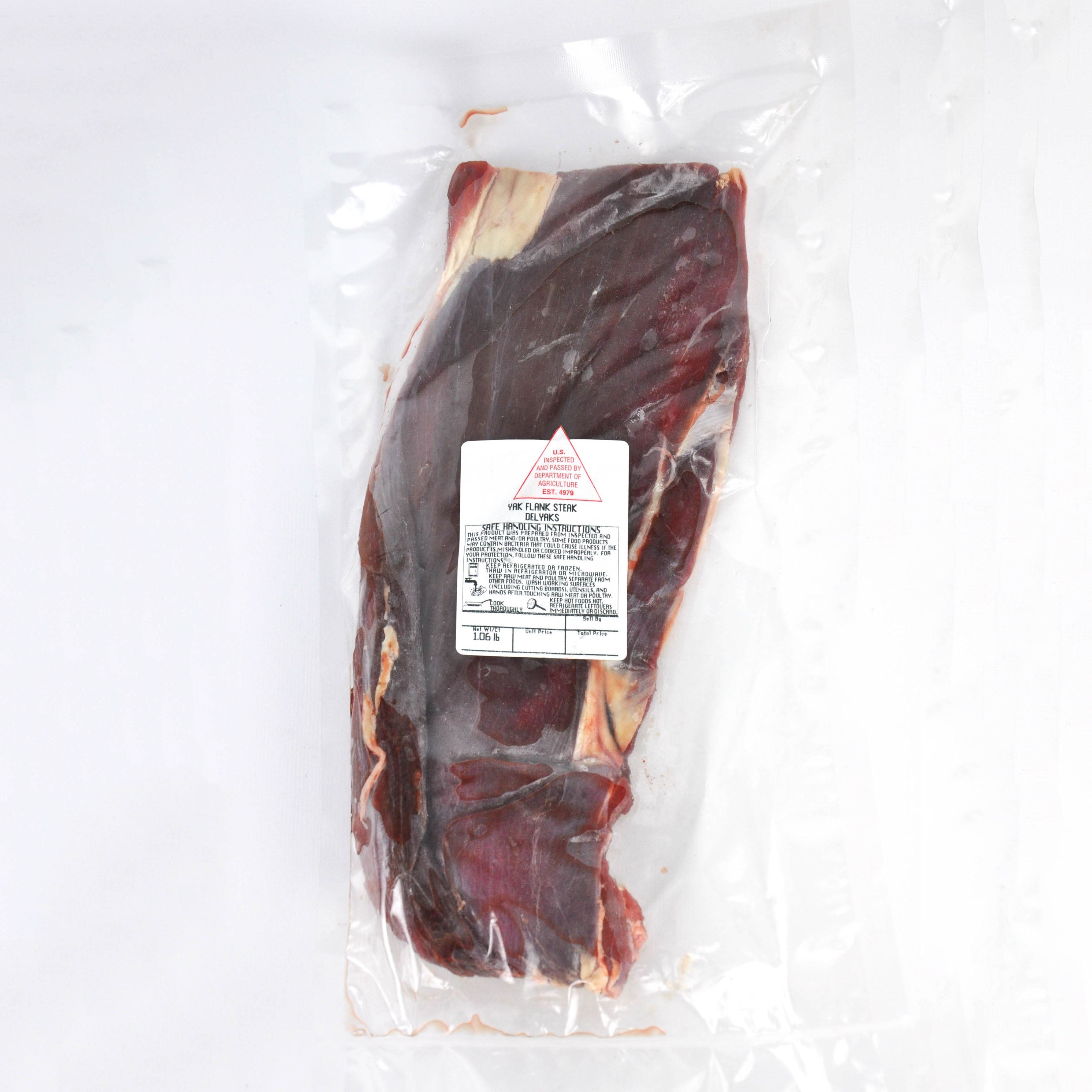 Vacuum-sealed package of meat with a label on a white background