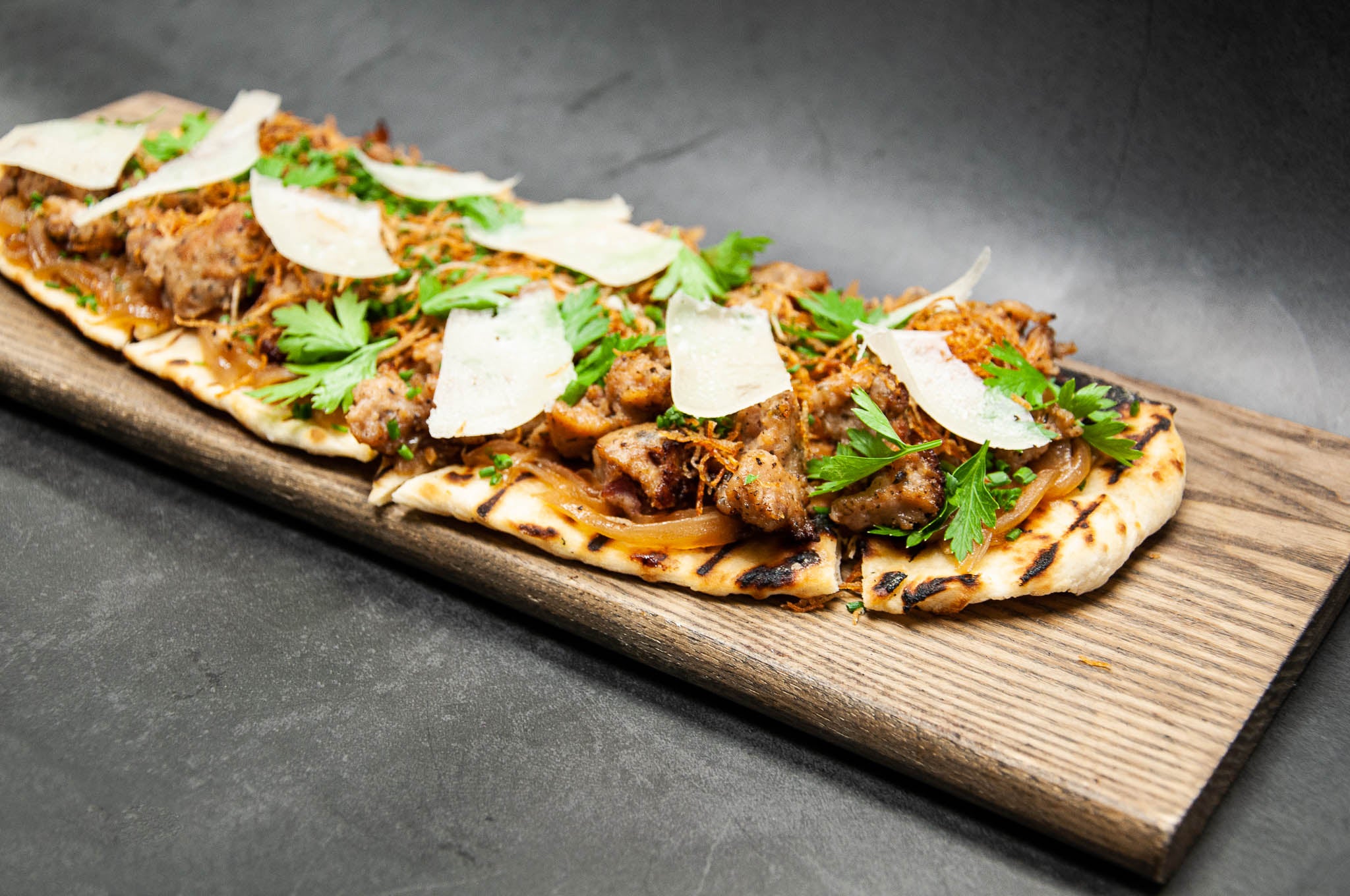 Rabbit Sausage Flatbread with Caramelized Onions & Manchego Cheese