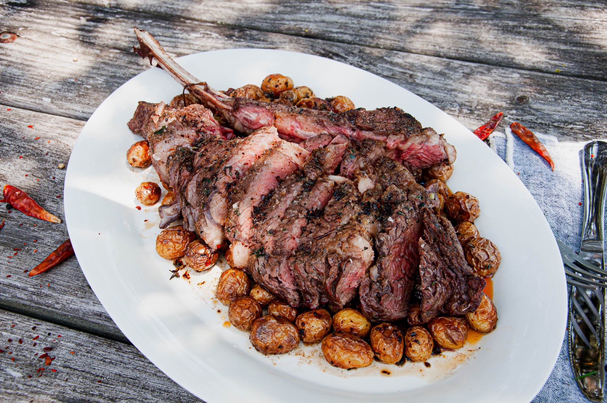 Reverse Grilled Bison Tomahawk with Honey Aleppo Roasted Petite Potatoes