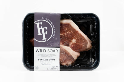 A package of FF Different by Nature Wild Boar Boneless Chops, showing two raw meat chops inside a black plastic tray with a dark purple and white paper label, set against a plain white background.