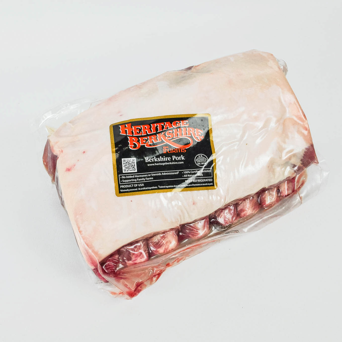 Packaged heritage Berkshire pork on a white background