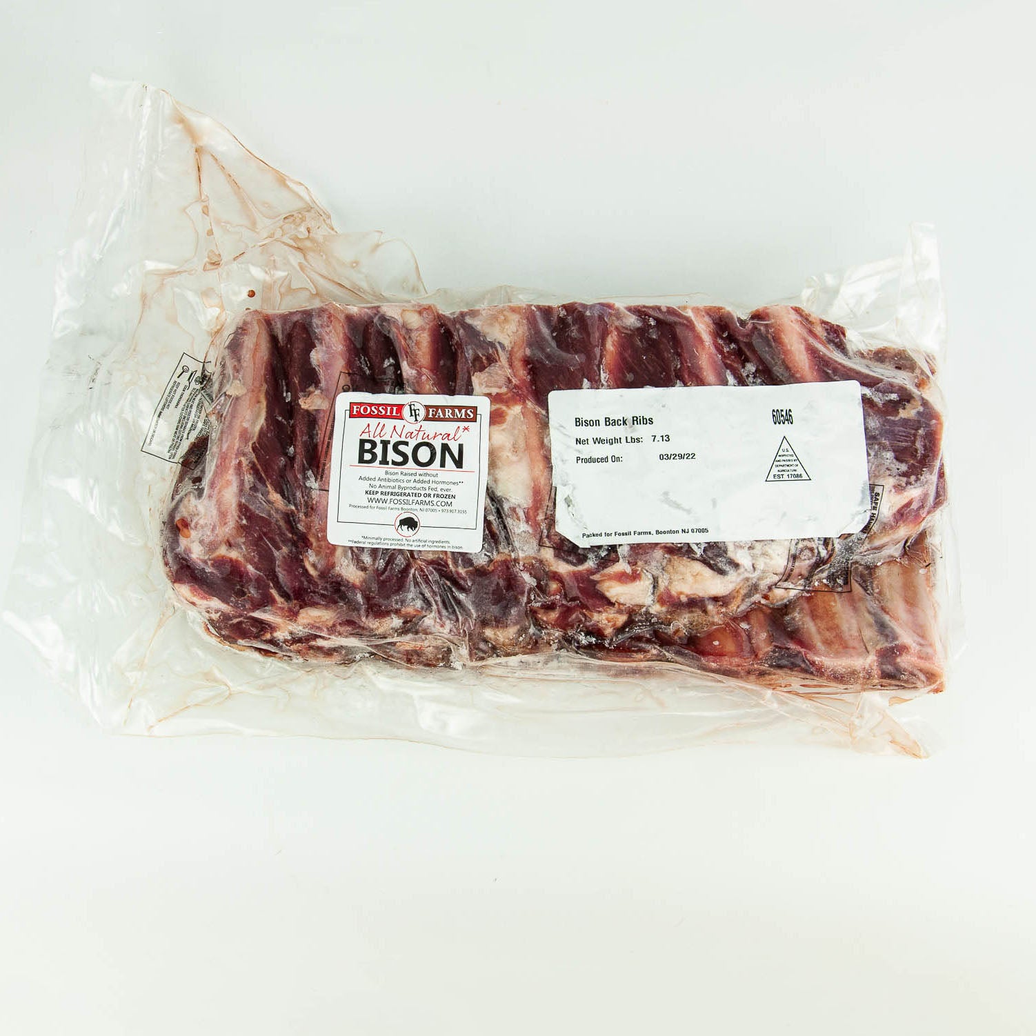 Packaged bison ribs with a label on a white background