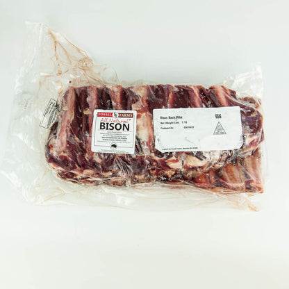 Packaged bison ribs with a label on a white background