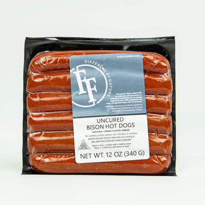 Packaged uncured bison hot dogs with a label on a white background