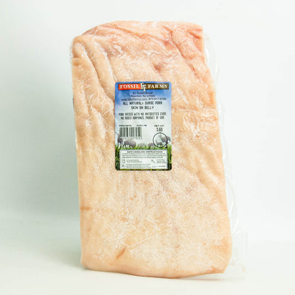 Raw pork belly with a label on a white background