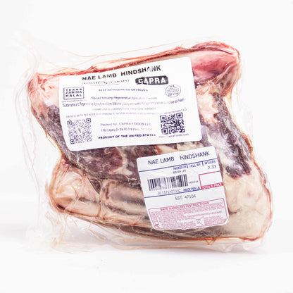 Packaged lamb hindshank with labels on a white background