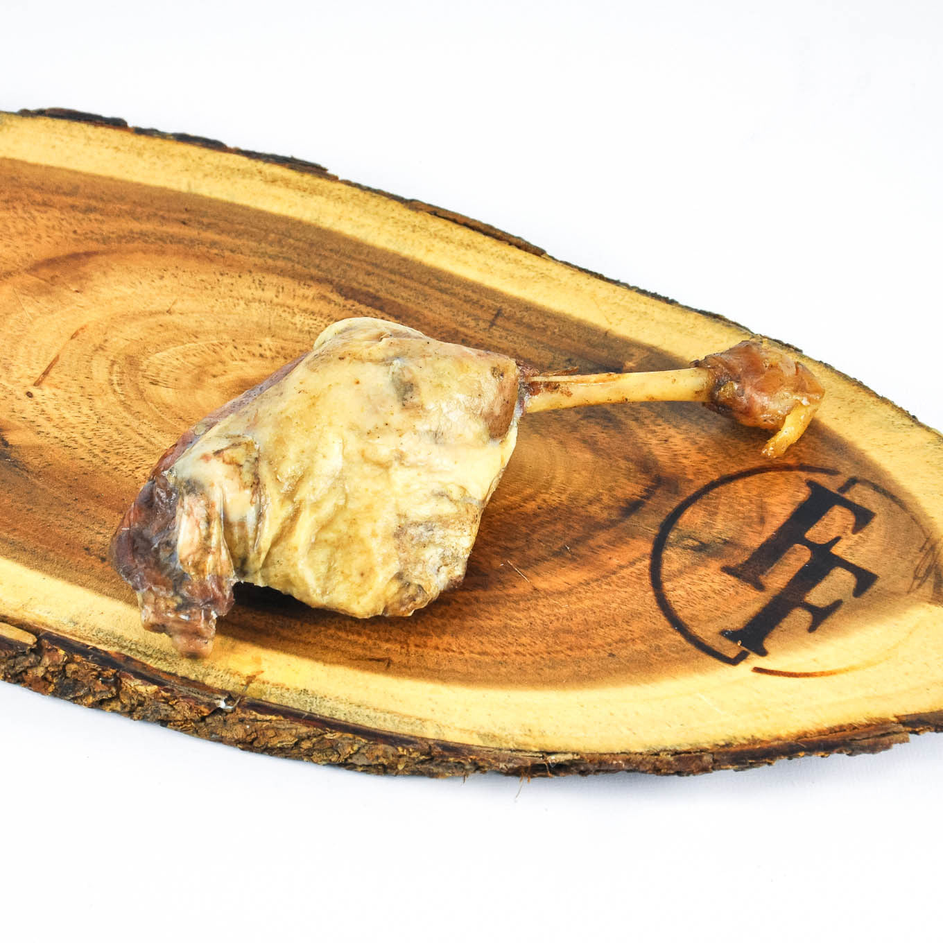 Wooden board with a piece of oyster on a stick and a logo on a white background