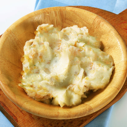 Mashed potatoes in a wooden bowl on a light blue background