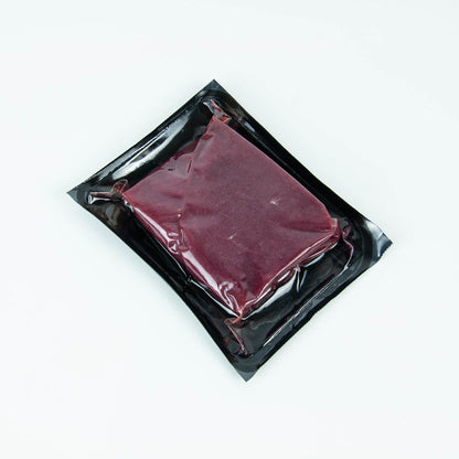 Vacuum-sealed package of raw meat on a white background