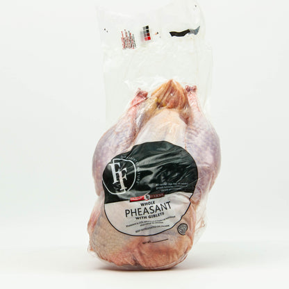 Whole pheasant in a clear plastic bag with a label on a white background