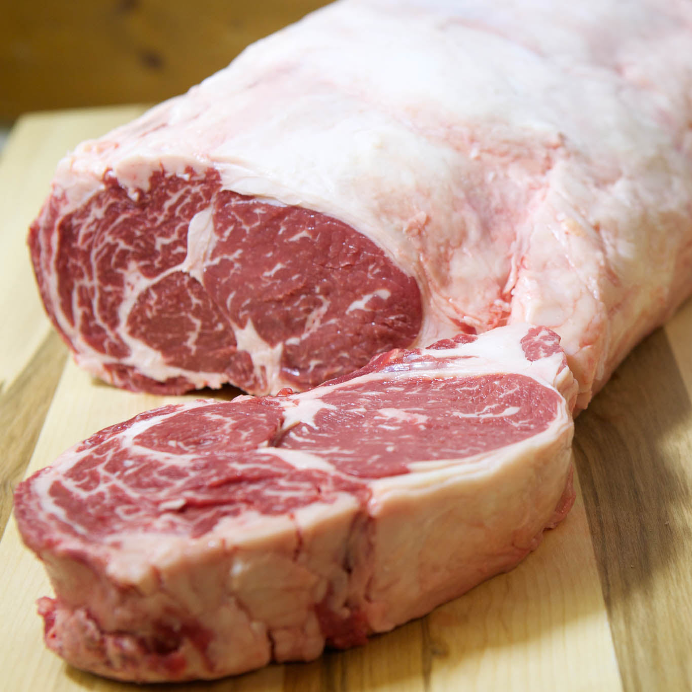 Raw pork loin with a cutout on a wooden surface