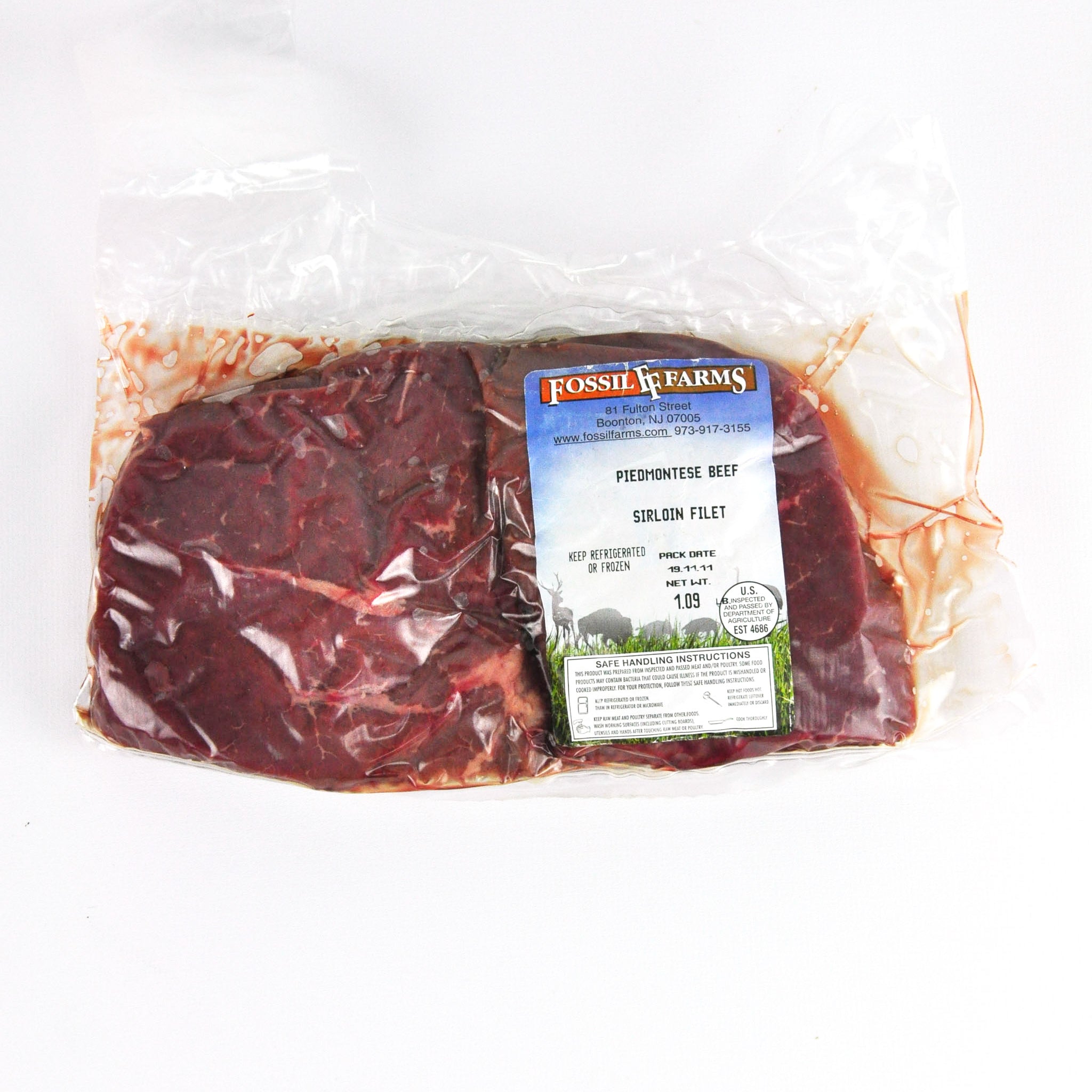 Packaged beef with Fossils Farms label on a white background