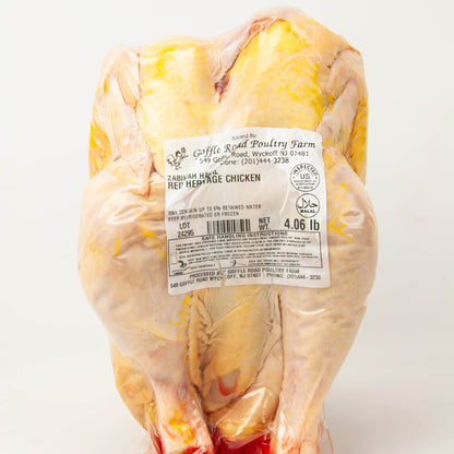 Raw chicken with a label on a white background