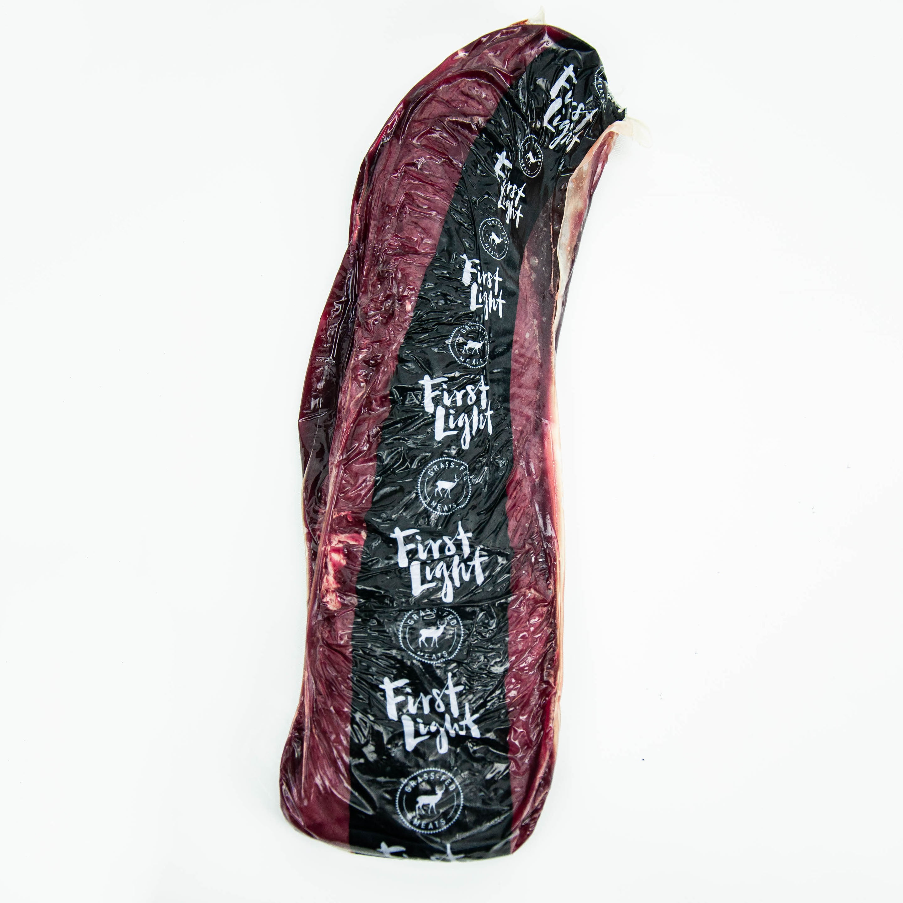 Raw meat slab with 'First Light' branding on a white background