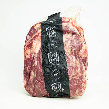 Packaged meat with 'First Light Farms' label on a white background