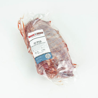 Packaged meat with a label on a white background