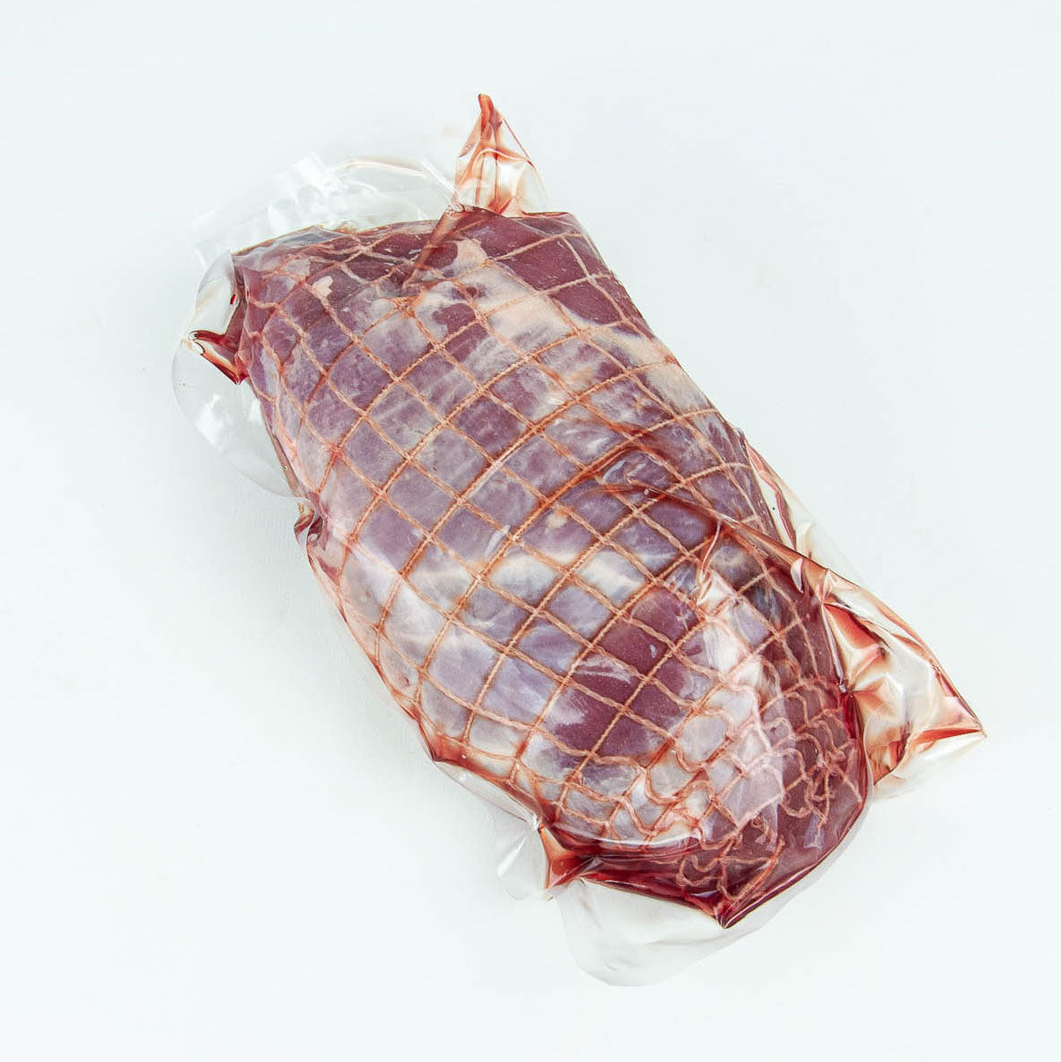 Vacuum-sealed package of raw meat on a white background