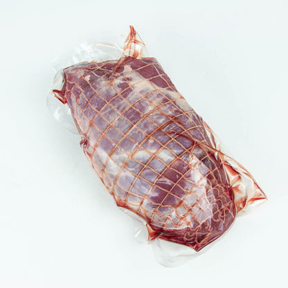 Vacuum-sealed package of raw meat on a white background