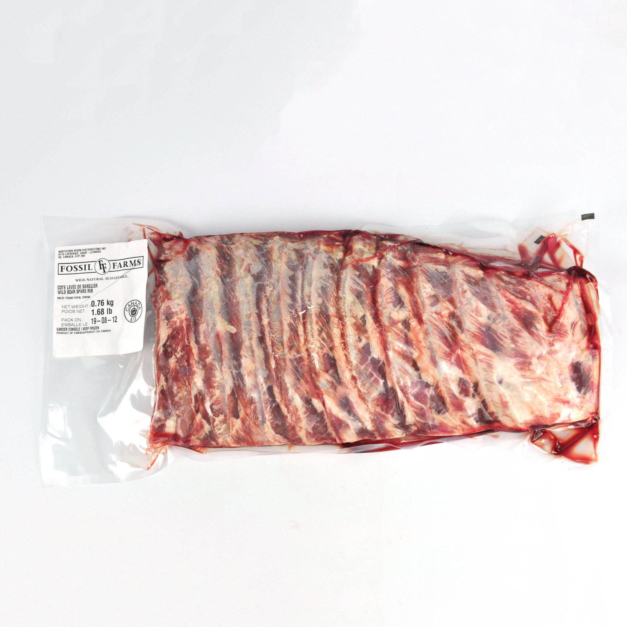 Packaged raw ribs with a label on a white background