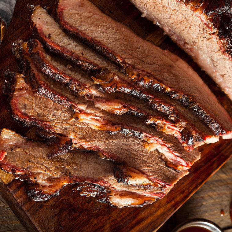 Sliced brisket on a wooden cutting board