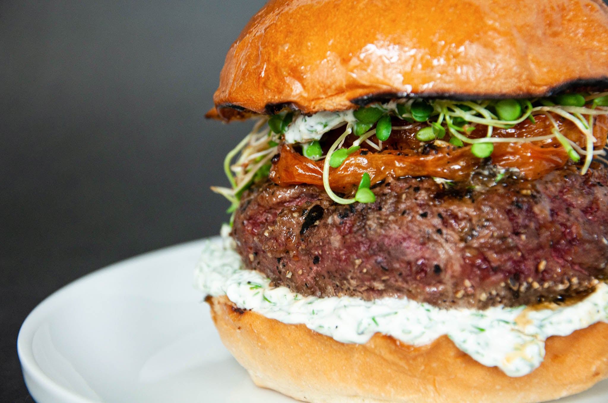 Ostrich Burger with Yogurt Dill Sprouts and Roasted Tomato 