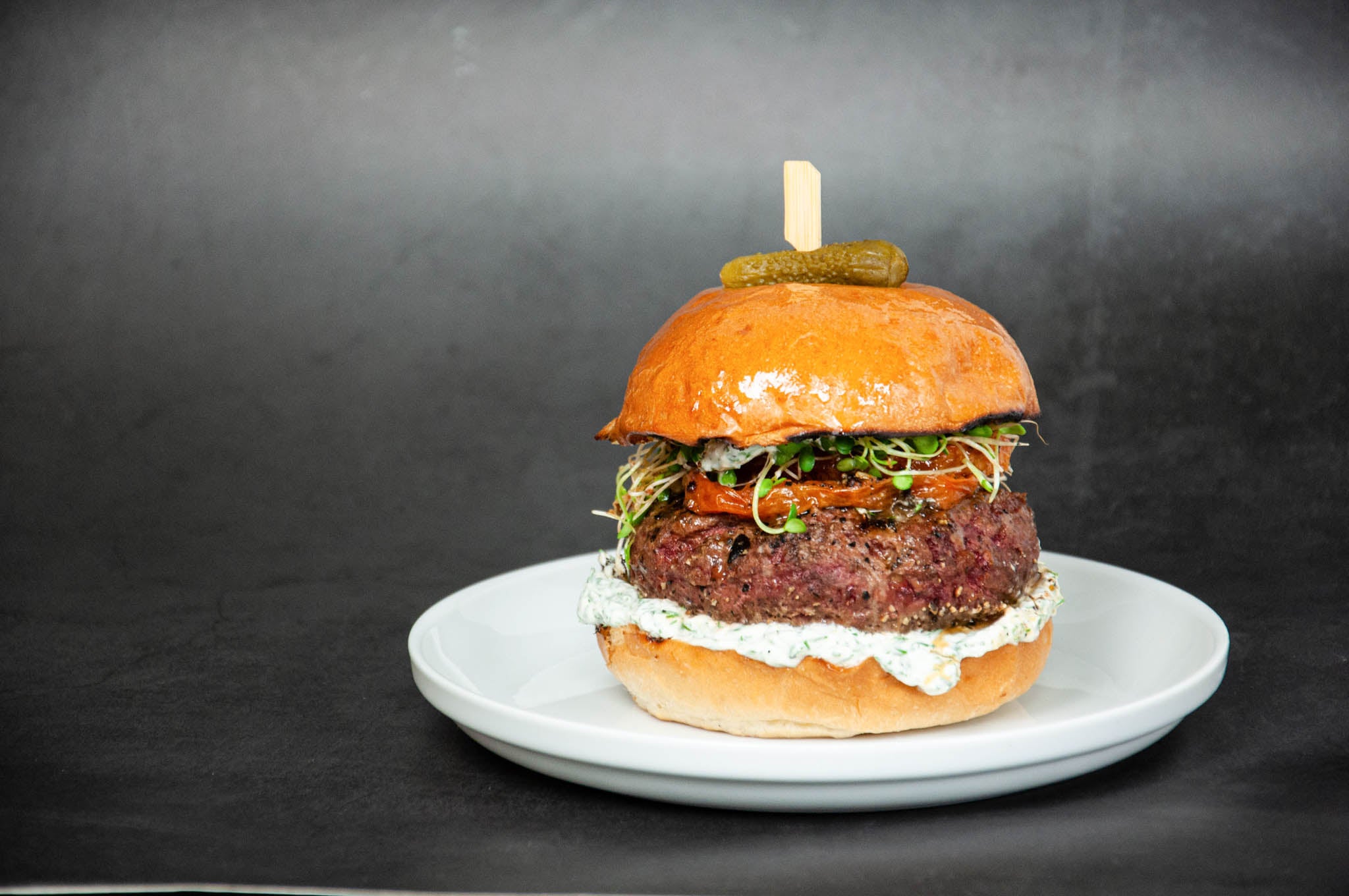 Ostrich Burger with Yogurt Dill Sprouts and Roasted Tomato 